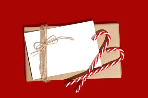 Gift box or present wrapped in craft paper with blank white card. Christmas Stock Photos