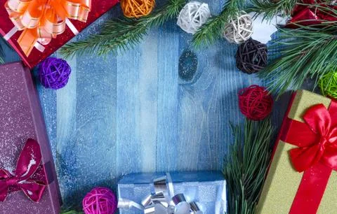 Gift box with pine branches on blue background Stock Photos