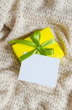Gift Box. Present With Empty Postcard on Knitted blanket background. Stock Photos