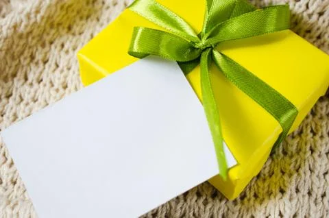 Gift Box. Present With Empty Postcard on Knitted blanket background. Stock Photos