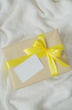 Gift Box. Present With Empty Postcard on Knitted blanket background. Stock Photos