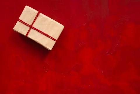 Gift box on red backdrop Stock Photos