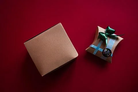 Gift box on a red background. Craft paper and handmade decoration 写真素材