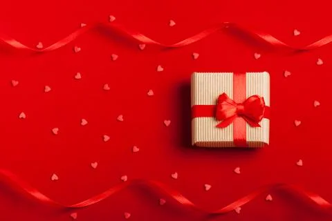 A gift in a box on a red background Stock Photos