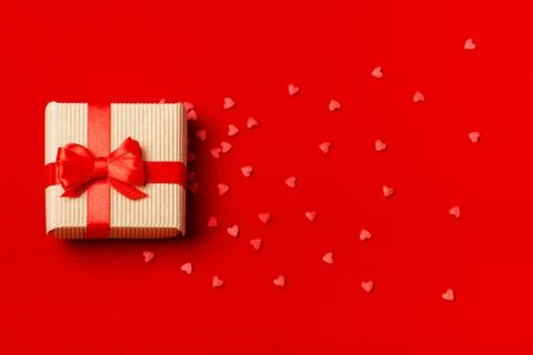 A gift in a box on a red background Stock-Fotos