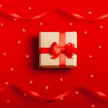 A gift in a box on a red background Stock Photos