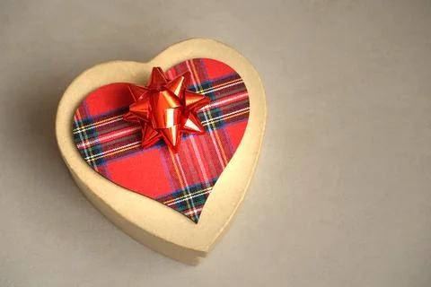 Gift box with red bow and red tartan Scottish pattern heart Stock Photos