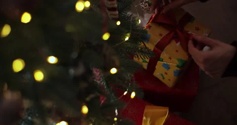 Gift box with a red bow place on top of a stack of gift boxes with christmas Stock Footage 221477475