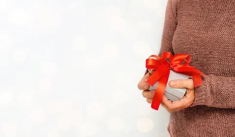 Gift box with a red bow in senior hands Stock Photos