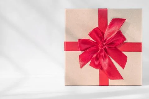 Gift box with red bow on white background. Holiday greeting card Stock Photos