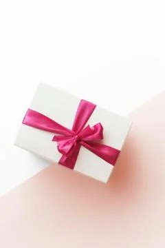 Gift Box with Red Ribbon on Pink Background Stock Photos
