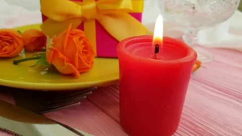 Gift box rose flower plate slow motion, candle fire Stock Footage 96096366