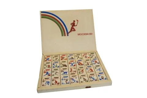 Gift box with a set of matches with Olympic symbols on a white background. Stock Photos