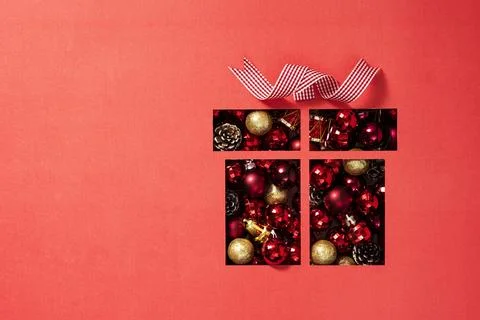 Gift box shape cut out from red paper with Christmas ornaments Stockfoto's