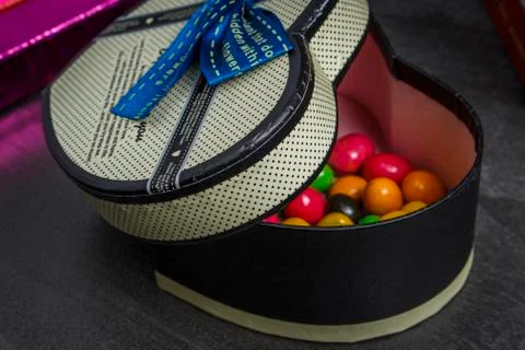 Gift box in the shape of heart with sweets inside Stock Photos