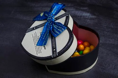 Gift box in the shape of heart with sweets inside Stock Photos