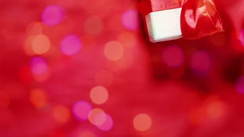 Gift box on a shimmering red background Stock Footage 139705342