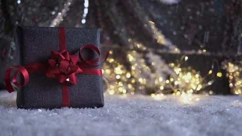 Gift box on silver shiny background. Falling snow on silver background. Stock Footage 166032329