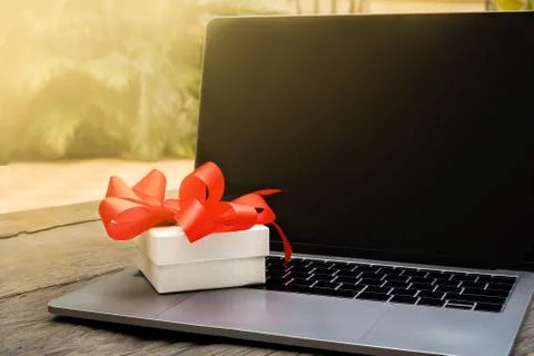 The gift box stands on the computer keyboard Stock Photos