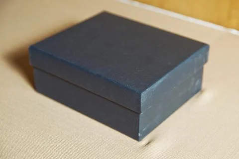 Gift box on the table . The blue box is on the white table . Stock Photos