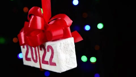 Gift box with text 2022 rotating on black background Stock Footage 161074305
