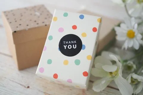 Gift box with thank you note and flowers 写真素材