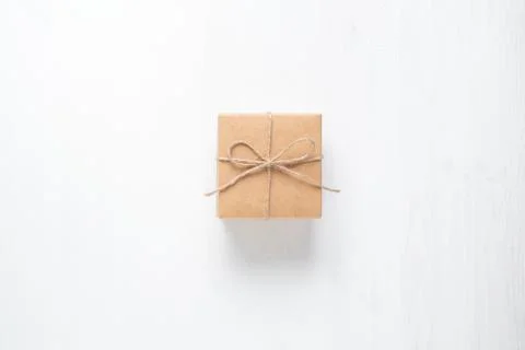 Gift box tied with string on a white background Stock Photos