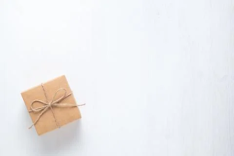 Gift box tied with string on a white background Stock Photos