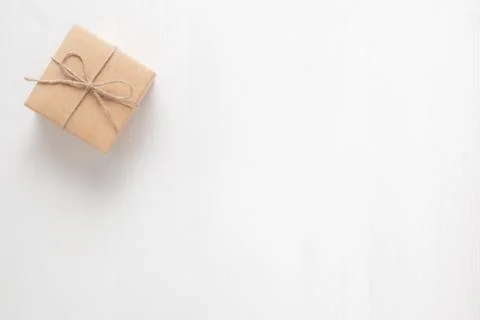 Gift box tied with string on a white background Stock Photos