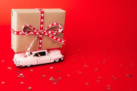 Gift box on valentines day on red background. Stock Photos