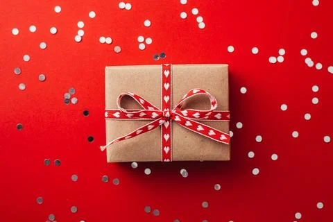 Gift box on valentines day on red background. Stock Photos