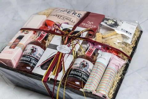 Gift box with various chocolates and snacks. Stock Photos