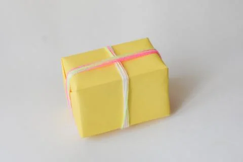 Gift box on a white background. winter holidays, pompom from threads, warm Stock Photos