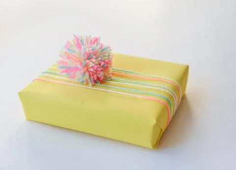 Gift box on a white background. winter holidays, pompom from threads, warm Foto stock