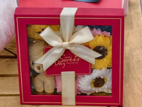 Gift box with a white satin bow Stock Photos