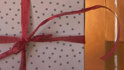 Gift box wrapped with a bow with bottle of white wine Stock Footage 156815569