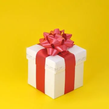 Gift box on yellow Stock Photos