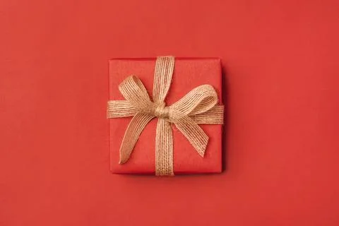 Gift boxe with bow on a red backdrop. Stock Photos