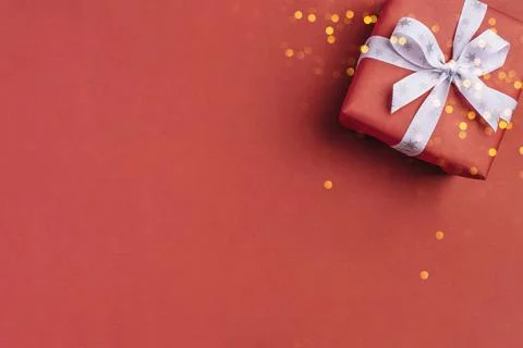 Gift boxe with white bow on a red backdrop. Stock Photos