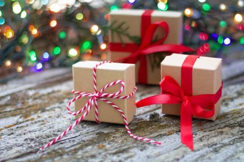 Gift boxes against a background bokeh of twinkling party lights. Christmas an Stock Photos
