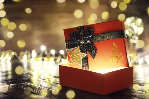 Gift boxes against a background bokeh of twinkling party lights. Luxury New.. Stock Photos