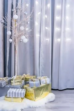 Gift boxes against a background bokeh of twinkling party lights. Luxury New.. Stock Photos