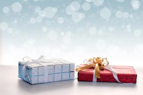 Gift boxes against bokeh background Stock Photos