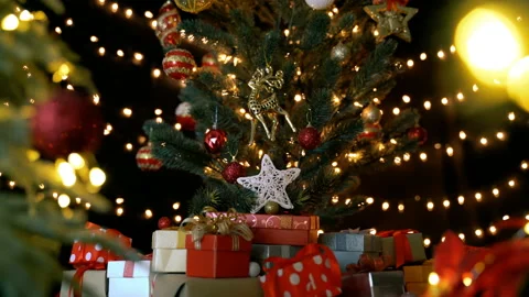 Gift boxes and christmas decorations under a beautiful decorated christmas tree Stock Footage 141307785