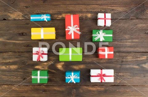 Gift boxes and colorful present for christmas on wood table. Top view with co Stock Photos