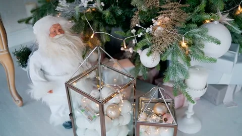 Gift boxes and decorations under the tree. Toy Santa Claus. Stock Footage 163349008