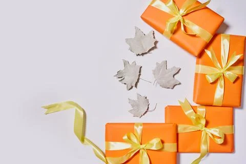 Gift boxes and fall leaves on white Stock Photos