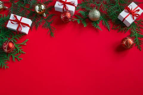 Gift boxes and festive decor. Christmas composition on red background. Stock Photos