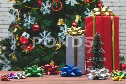 Gift boxes arange with colourful bows on wood board, Background with blurred Stock Photos