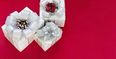 Gift boxes are isolated on a red background with copy space Stock Photos